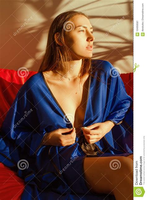 Beautiful Girl In Blue Silk Robe Resting In The Sunlight Stock Image