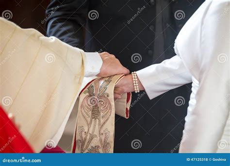 Priest Giving Blessing To A Couple At A Wedding Ceremony Stock Photo