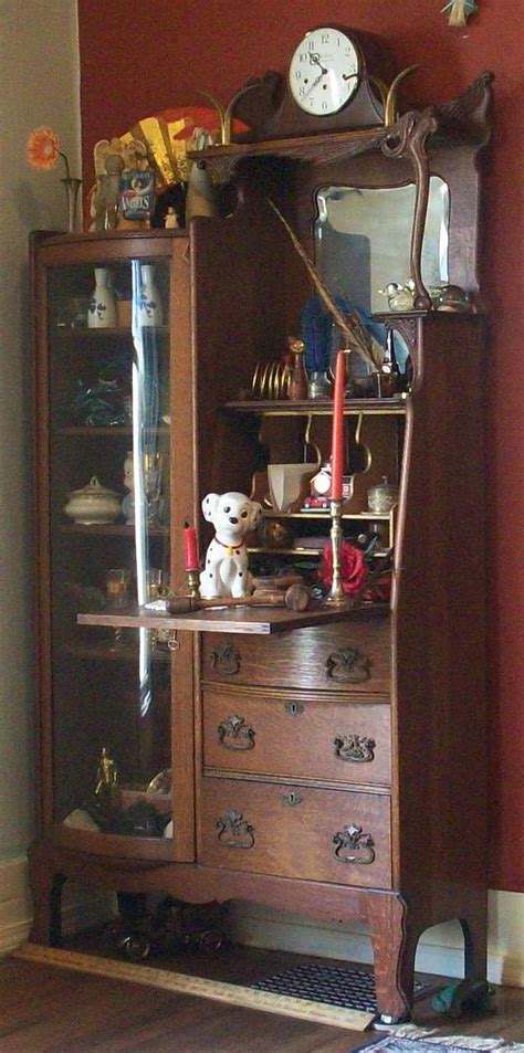 Mirrored curio cabinets create an illusion of a larger space with their reflection. Antique oak secretary with curved glass curio cabinet For ...