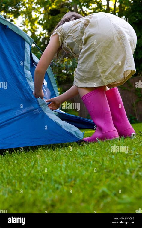Back Of Young Girl Bending Over Fixing Tent Stock Photo Alamy