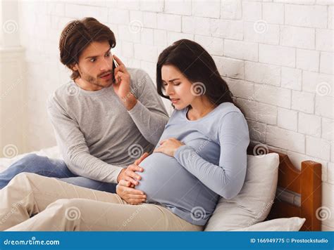 Worried Husband Calling Doctor For His Pregnant Wife Having