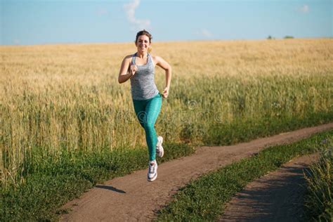 Woman Jogger Working Out In The Morning Sunny Day Stock Photo Image