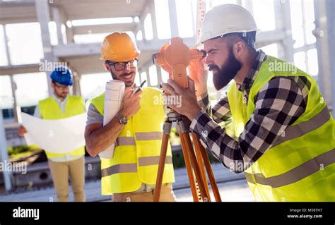 Portrait Of Construction Engineers Working On Building Site Stock Photo