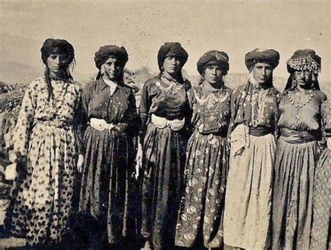 An Old Black And White Photo Of Women In Long Dresses Standing Next To