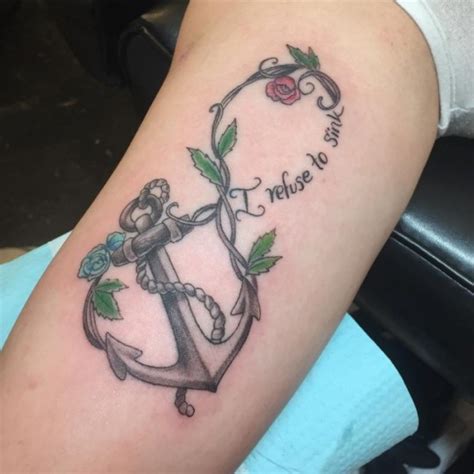 A painted anchor design that is combined with some beautiful flowers. Anchor Tattoos