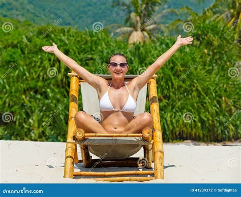 Girl On A Tropical Beach Sitting At Chaise Lounge Stock Photo Image