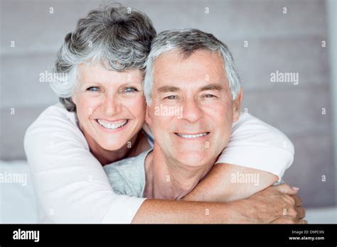 Mature Woman Embracing Her Husband Stock Photo Alamy