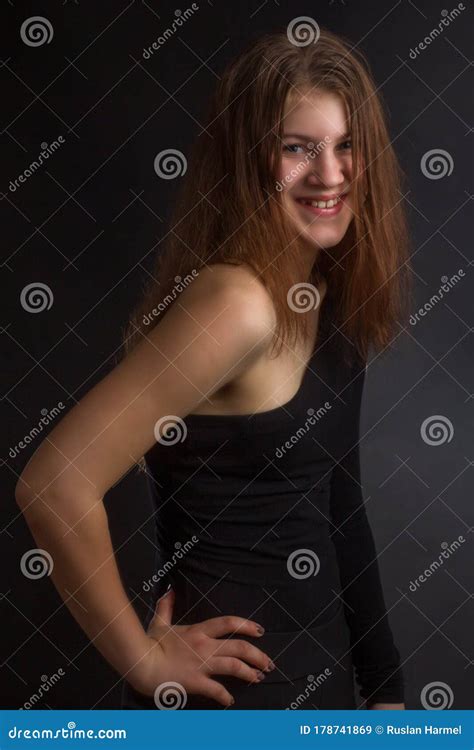 Portrait Of Girl In A Black One Shoulder Dress Open Naked Studio On