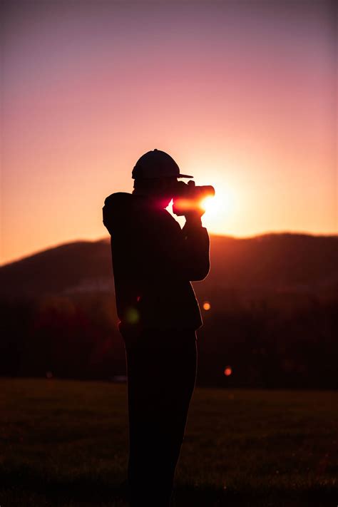 Download Man Taking Photo During Sunset Photography Wallpaper