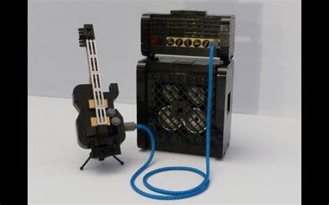 An Electric Guitar Is Plugged Into A Small Speaker With A Blue Cord