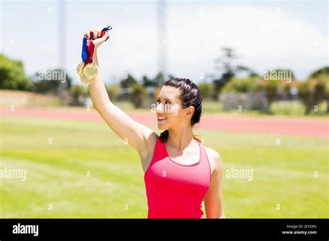 Happy Female Athlete Showing Her Gold Medals Stock Photo Alamy