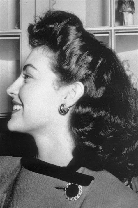 An Old Black And White Photo Of A Woman Smiling