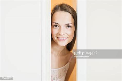 woman peeking door photos and premium high res pictures getty images