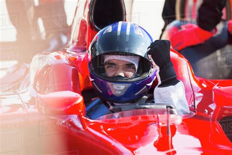 Formula One Race Car Driver In Helmet Gesturing Celebrating Victory