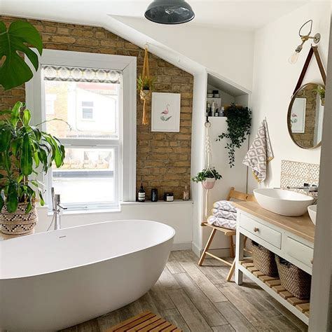 A crisp white freestanding cottage bathroom storage furniture narrow floor cabinets cabinet. Stand alone bath tub with exposed bricks, double sinks on ...