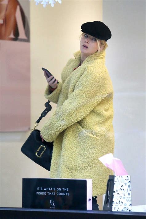 Jennifer Lawrence In A Yellow Fur Coat Does Some Christmas Shopping In