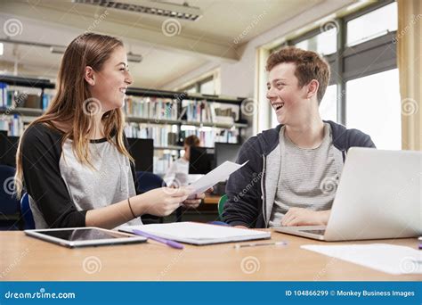 Two College Students Collaborating On Project In Library Stock Image