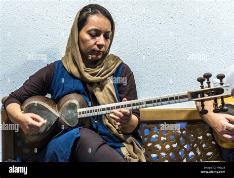 Woman Playing On Tar Instrument During Performance For Visitors In Museum Of Music Homage To