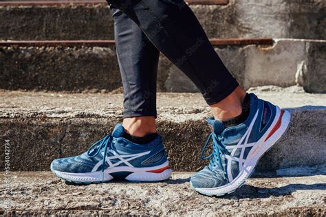 Male Sprinter Wearing Asics Gel Nimbus At Concrete Stairs Background