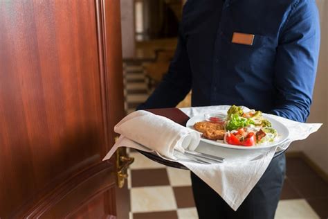 Premium Photo A Waiter Bring Breakfast Into The Hotel Room