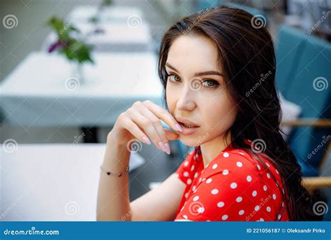A Sweet Girl With A Clean Perfect Face Looking At Camera And Tenderness Touching Her Lips Photo