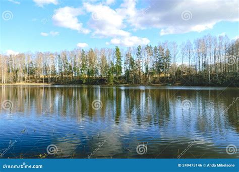 Spring Landscape With Reflections Of Lakes Clouds And Trees On A Calm
