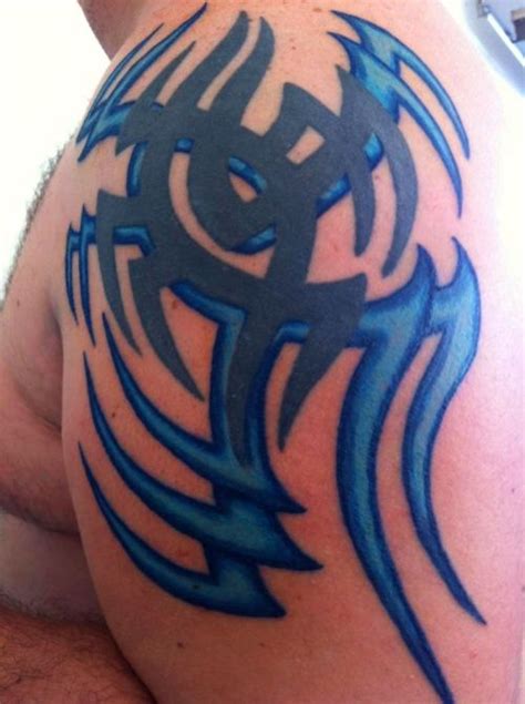 Blue And Black Tribal Tattoo On Shoulder