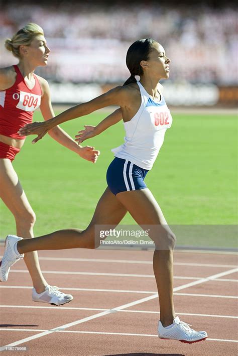 Female Runner Crossing Finish Line In Race High Res Stock Photo Getty