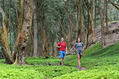 Hiking Couple Tourists Walking Together In Forest Trail Path In Summer Travel Vacation