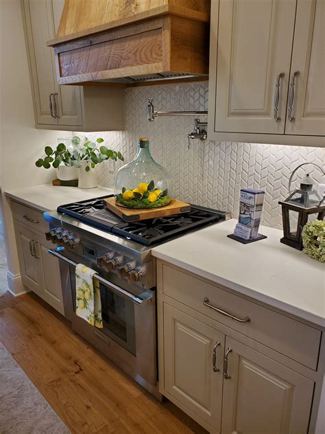 White kitchens remain among the most popular styles seen in homes. White quartz kitchen countertops with white tile ...