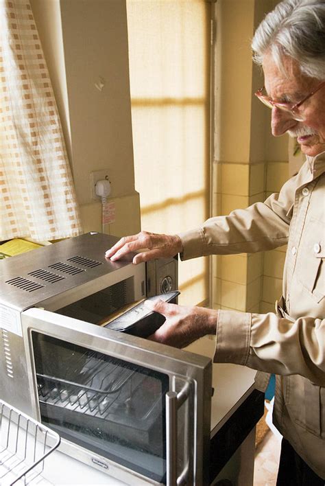 Elderly Man Using A Microwave Oven Photograph By Mary Dunkin Science Photo Library Fine Art