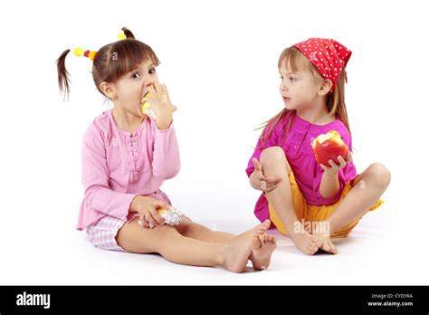 Portrait Of Cute Kids Eating Apples Over White Stock Photo Alamy