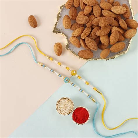 Send Sneh Vibrant Set Of 2 Pearl Rakhis Almonds Online Rakhibazaar Com