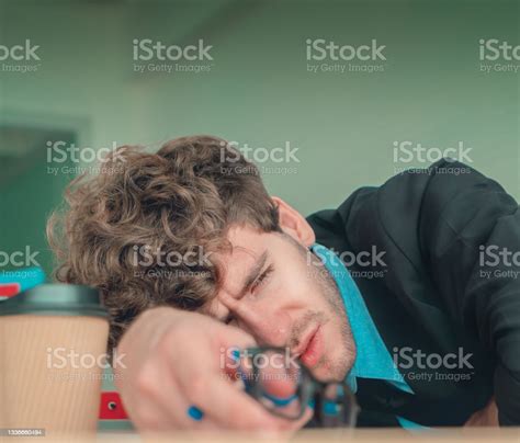 Hopeless Business Man Resting On The Office Desk With Frustation