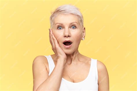 free photo portrait of shocked mature european female gasping with opened mouth taken by