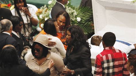 Mourners Embrace In Front Of The Open Casket Of Freddie Gray During His