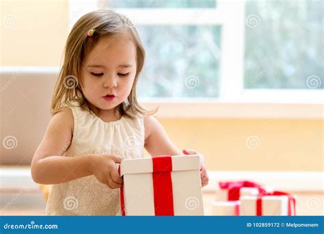Little Girl Opening A Christmas Present Stock Photo Image Of