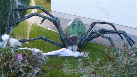 A Large Spider Statue Sitting On Top Of A Lush Green Grass Covered