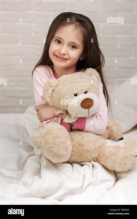 Adorable Little Child Girl Hugging Teddy Bear In Bed In Morning Stock