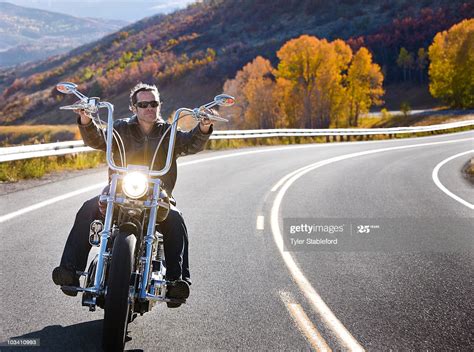 See more ideas about riding motorcycle, riding, motorcycle. Man Riding Motorcycle On Windy Road In Autumn High-Res ...