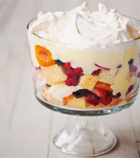 A Trifle With Fruit And Whipped Cream In A Glass Dish