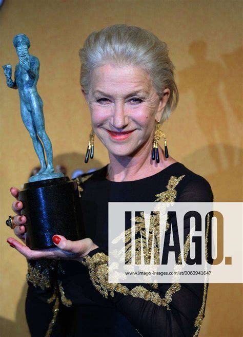 Actress Helen Mirren Holds The Award She Won For Best Female Actor In A Television Movie Or