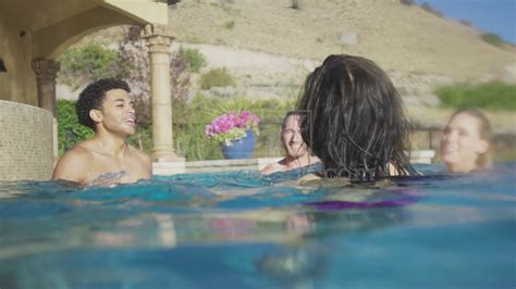 Medium Shot Of Friends Splashing In Swimming Pool Youtube