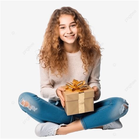 فتاة في سن المراهقة تعانق صندوق هدايا عيد الميلاد أثناء جلوسها على كرسي طفل عيد الميلاد عيد