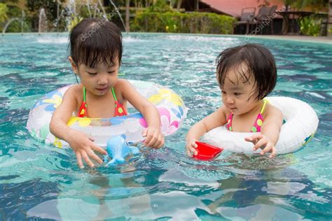 Asian Little Chinese Girls Playing In Swimming Pool Royalty Free Photo