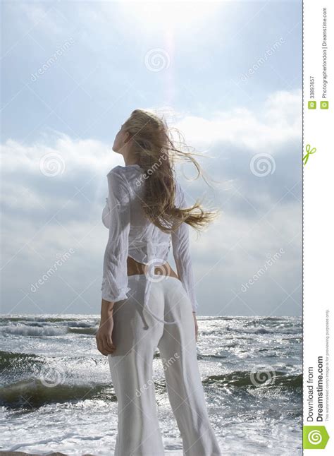 I look up at the sky quite often, both at day and night. Woman Looking Up At Sky Against Ocean Royalty Free Stock ...