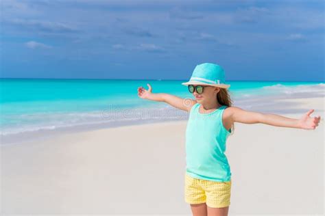 Cute Little Girl In Hat Walking At Beach During Caribbean Vacation