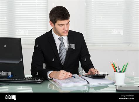 Businessman Calculating Bill Stock Photo Alamy