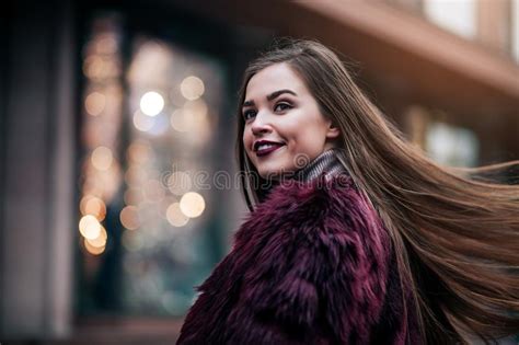 Young Beautiful Model Girl Smiles And Looks Back In The City
