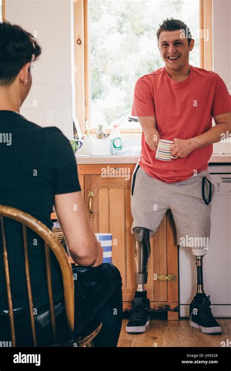 Quadriplegic Man Standing In His Kitchen He Is Having A Conversation